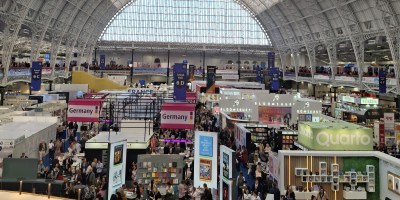 Venue shows many publishing stalls and is full of people.