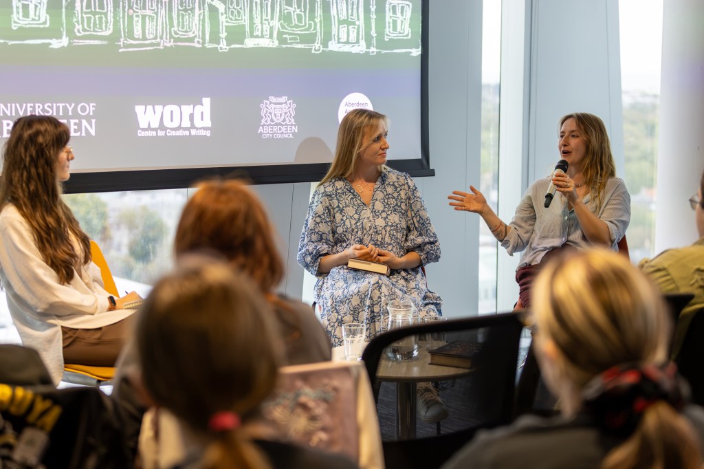 Authors Hannah Kaner and Georgia Leighton sit in front of the crowd, in conversation with chair Dora Grabar.